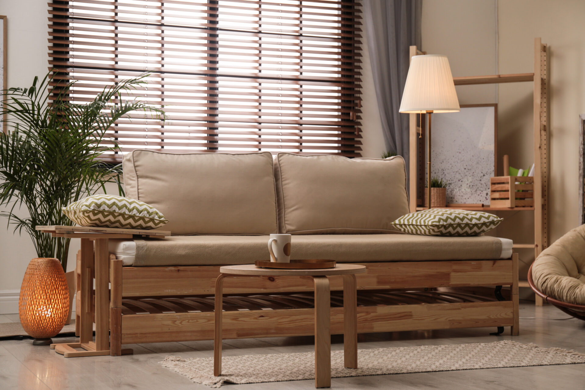 Living room interior with sofa, window blinds and stylish décor and faux wooden blinds