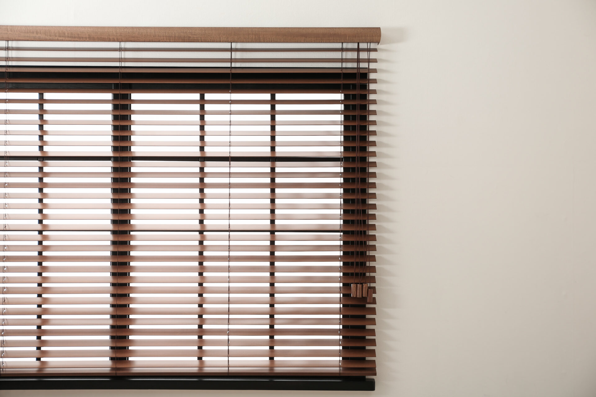 Modern window with stylish wooden blinds. Custom blinds for any indoor window at Wholesale Blind Factory.
